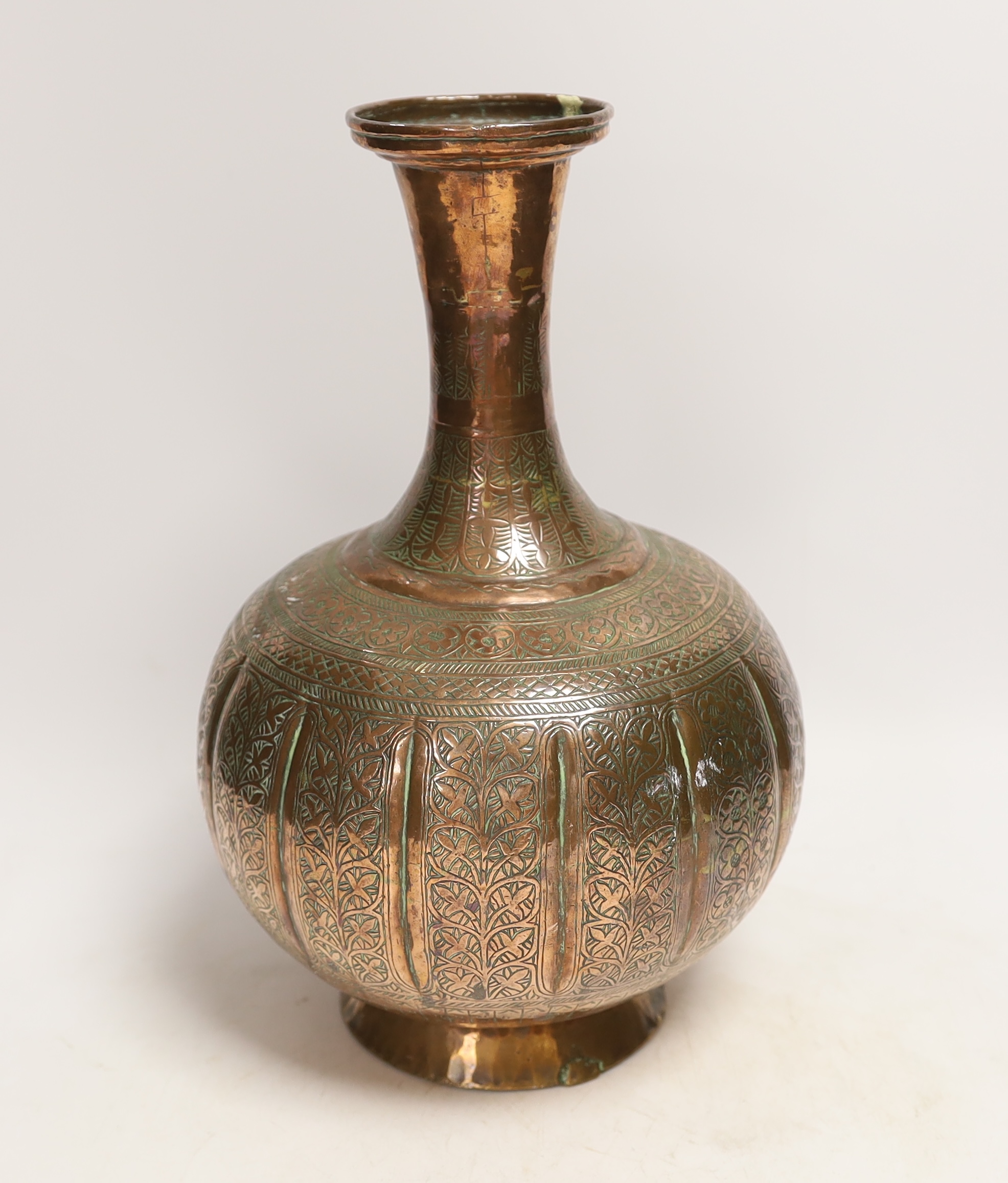 An Islamic engraved copper vase, 31cm